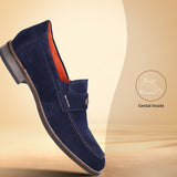 A blue Men's bugatti Penny Loafer featuring a round apron toe, moulded heel. Made from suede leather with a durable tr outsole, this slip-on design offers both style and comfort.