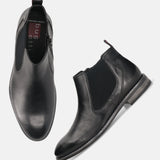 A black Men's bugatti Chelsea Boots featuring a round toe plain toe, moulded heel, and a wide fit. Made from premium genuine leather with a durable tr outsole, this zipper design offers both style and comfort.