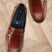 Men's Bugatti penny loafer cognac leather shoes with a pointed toe and apron toe featuring a moulded heel , a tpr outsole.