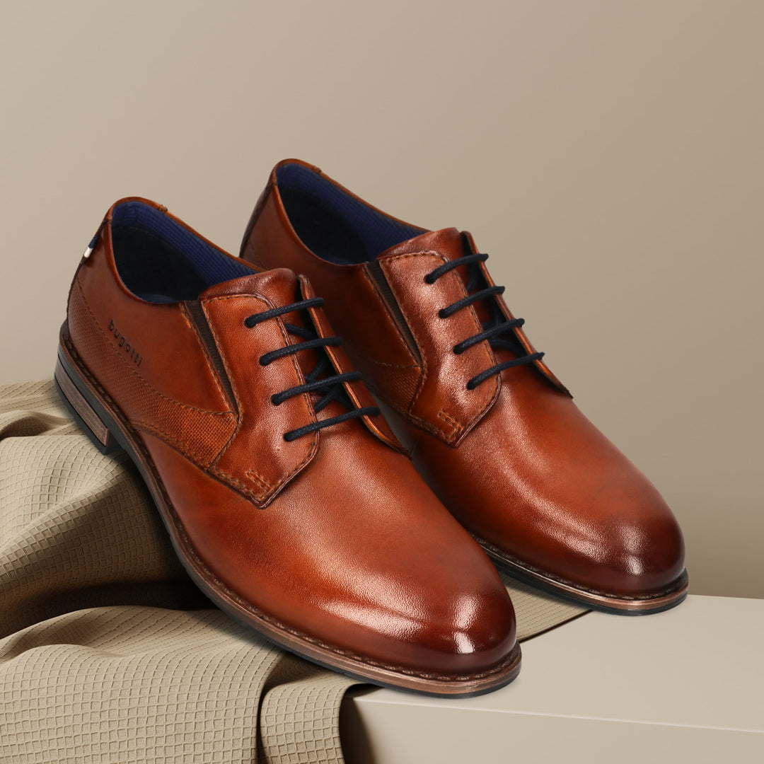 Men's Bugatti derby cognac leather shoes with a round toe and plain toe featuring a moulded heel , a tpr outsole , and laces fastening.