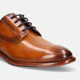 A cognac Men's bugatti Derby featuring a round plain toe, stacked heel. Made from premium genuine leather with a durable leather outsole, this laces design offers both style and comfort.