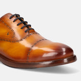 A yellow Men's bugatti Oxford featuring a round cap toe, stacked heel. Made from premium genuine leather with a durable leather outsole, this laces design offers both style and comfort.