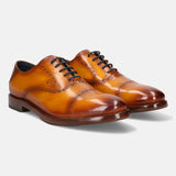 A yellow Men's bugatti Oxford featuring a round cap toe, stacked heel. Made from premium genuine leather with a durable leather outsole, this laces design offers both style and comfort.