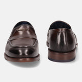 A brown Men's bugatti Venetian Loafers featuring a round toe apron toe, stacked heel. Made from premium genuine leather with a durable leather outsole, this slip-on design offers both style and comfort.