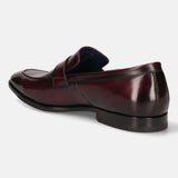 A grey Men's bugatti Penny Loafer featuring a round toe apron toe, stacked heel. Made from premium genuine leather with a durable leather outsole, this slip-on design offers both style and comfort.