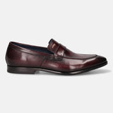 A grey Men's bugatti Penny Loafer featuring a round toe apron toe, stacked heel. Made from premium genuine leather with a durable leather outsole, this slip-on design offers both style and comfort.