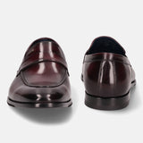 A grey Men's bugatti Penny Loafer featuring a round toe apron toe, stacked heel. Made from premium genuine leather with a durable leather outsole, this slip-on design offers both style and comfort.