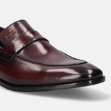 A grey Men's bugatti Penny Loafer featuring a round toe apron toe, stacked heel. Made from premium genuine leather with a durable leather outsole, this slip-on design offers both style and comfort.