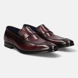 A grey Men's bugatti Penny Loafer featuring a round toe apron toe, stacked heel. Made from premium genuine leather with a durable leather outsole, this slip-on design offers both style and comfort.