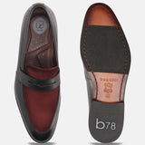 A black Men's bugatti Penny Loafer featuring a round toe apron toe, stacked heel. Made from premium genuine leather with a durable leather outsole, this slip-on design offers both style and comfort.
