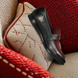 A black Men's bugatti Penny Loafer featuring a round toe apron toe, stacked heel. Made from premium genuine leather with a durable leather outsole, this slip-on design offers both style and comfort.