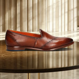 A cognac Men's bugatti Venetian Loafers featuring a round toe plain toe, stacked heel. Made from premium genuine leather with a durable leather outsole, this slip-on design offers both style and comfort.