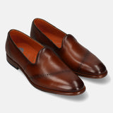 A cognac Men's bugatti Venetian Loafers featuring a round toe plain toe, stacked heel. Made from premium genuine leather with a durable leather outsole, this slip-on design offers both style and comfort.