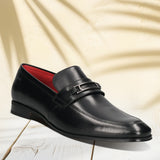 A black Men's bugatti Bit Loafer featuring a round toe apron toe, moulded heel. Made from premium genuine leather with a durable high quality synthetic outsole, this slip-on design offers both style and comfort.