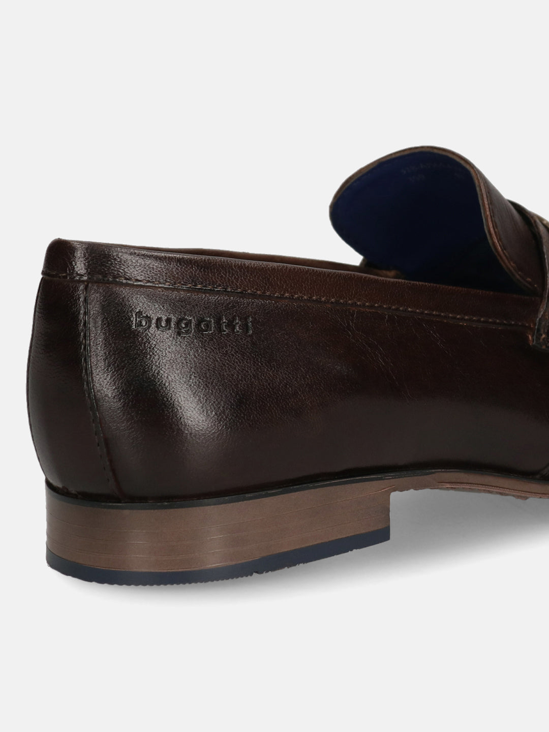 A brown Men's bugatti Bit Loafer featuring a round toe apron toe, moulded  heel. Made from premium genuine leather with a durable high quality synthetic outsole, this slip-on design offers both style and comfort.