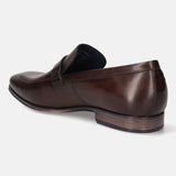 A brown Men's bugatti Bit Loafer featuring a round toe apron toe, stacked heel. Made from premium genuine leather with a durable high quality synthetic outsole, this slip-on design offers both style and comfort.