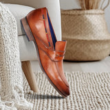 A cognac Men's bugatti Penny Loafer featuring a round toe apron toe, stacked heel. Made from premium genuine leather with a durable high quality synthetic outsole, this slip-on design offers both style and comfort.