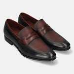 A black Men's bugatti Penny Loafer featuring a round toe apron toe, moulded  heel. Made from premium genuine leather with a durable high quality synthetic outsole, this slip-on design offers both style and comfort.