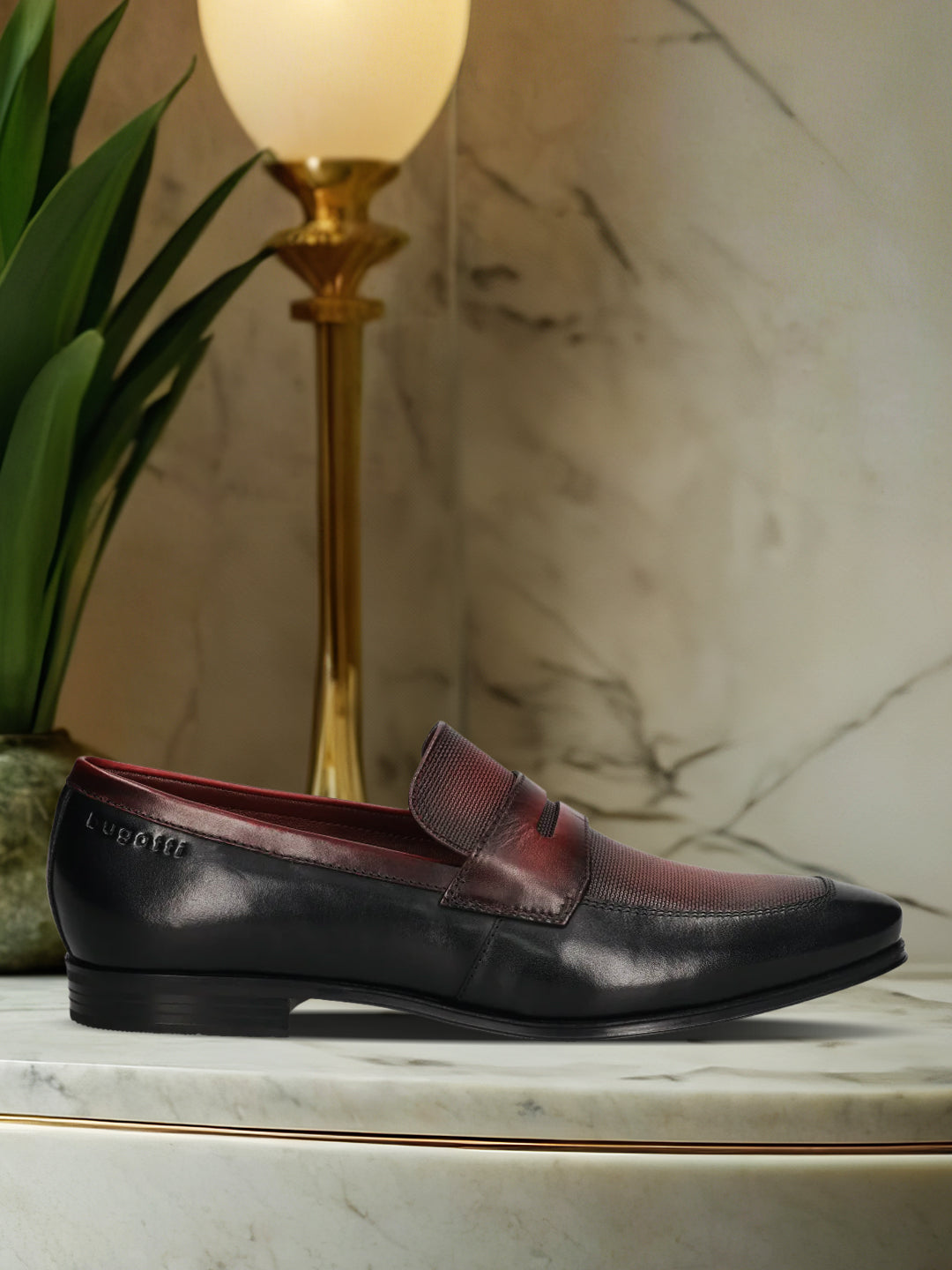 A black Men's bugatti Penny Loafer featuring a round toe apron toe, moulded  heel. Made from premium genuine leather with a durable high quality synthetic outsole, this slip-on design offers both style and comfort.