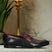 A black Men's bugatti Penny Loafer featuring a round toe apron toe, moulded  heel. Made from premium genuine leather with a durable high quality synthetic outsole, this slip-on design offers both style and comfort.