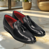 A black Men's bugatti Tassel Loafers featuring a round toe plain toe, moulded heel. Made from premium genuine leather with a durable high quality synthetic outsole, this slip-on design offers both style and comfort.
