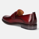 A grey Men's bugatti Penny Loafer featuring a round apron toe, moulded heel. Made from premium genuine leather with a durable tr outsole, this slip-on design offers both style and comfort.