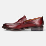 A grey Men's bugatti Penny Loafer featuring a round apron toe, moulded heel. Made from premium genuine leather with a durable tr outsole, this slip-on design offers both style and comfort.