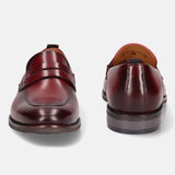 A grey Men's bugatti Penny Loafer featuring a round apron toe, moulded heel. Made from premium genuine leather with a durable tr outsole, this slip-on design offers both style and comfort.