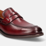A grey Men's bugatti Penny Loafer featuring a round apron toe, moulded heel. Made from premium genuine leather with a durable tr outsole, this slip-on design offers both style and comfort.