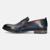 A blue Men's bugatti Penny Loafer featuring a round apron toe, moulded heel. Made from premium genuine leather with a durable tr outsole, this slip-on design offers both style and comfort.