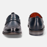 A blue Men's bugatti Penny Loafer featuring a round apron toe, moulded heel. Made from premium genuine leather with a durable tr outsole, this slip-on design offers both style and comfort.