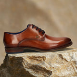Men's Bugatti derby cognac leather shoes with a round toe and plain toe featuring a moulded heel , a tpr outsole , and laces fastening.