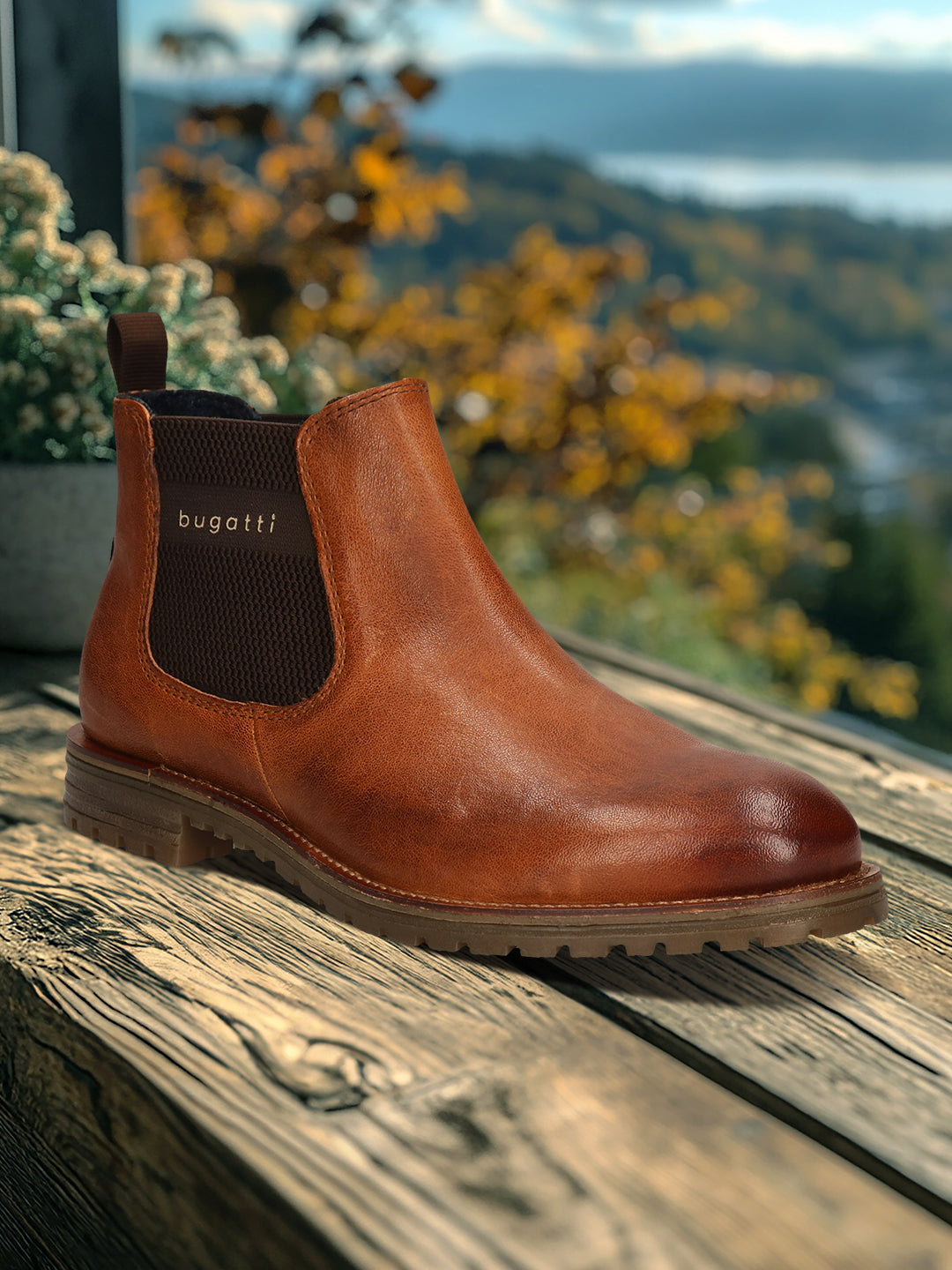 A cognac Men's bugatti Chelsea Boots featuring a round toe plain toe, moulded  heel, and a wide fit. Made from premium genuine leather with a durable tr outsole, this elastic design offers both style and comfort.