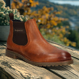A cognac Men's bugatti Chelsea Boots featuring a round toe plain toe, moulded  heel, and a wide fit. Made from premium genuine leather with a durable tr outsole, this elastic design offers both style and comfort.