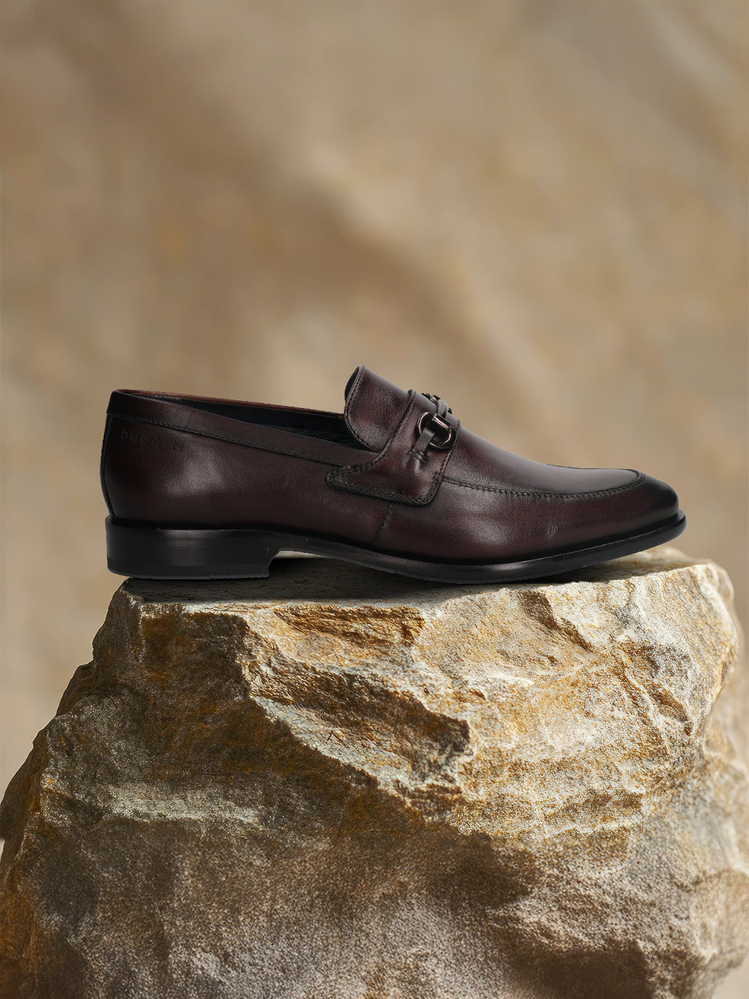 A grey Men's bugatti Bit Loafer featuring a round toe apron toe, stacked heel. Made from premium genuine leather with a durable leather outsole, this slip-on design offers both style and comfort.