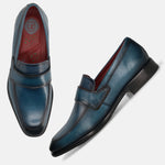 A blue Men's bugatti Penny Loafer featuring a round toe apron toe, stacked heel. Made from premium genuine leather with a durable leather outsole, this slip-on design offers both style and comfort.