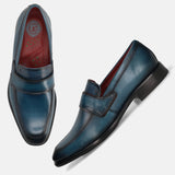 A blue Men's bugatti Penny Loafer featuring a round toe apron toe, stacked heel. Made from premium genuine leather with a durable leather outsole, this slip-on design offers both style and comfort.