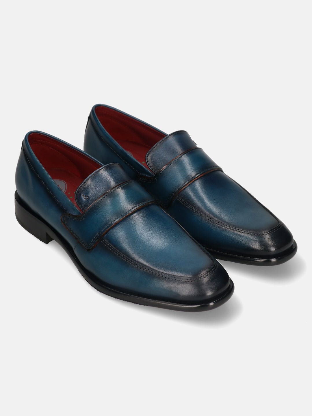A blue Men's bugatti Penny Loafer featuring a round toe apron toe, stacked heel. Made from premium genuine leather with a durable leather outsole, this slip-on design offers both style and comfort.