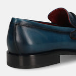 A blue Men's bugatti Penny Loafer featuring a round toe apron toe, stacked heel. Made from premium genuine leather with a durable leather outsole, this slip-on design offers both style and comfort.