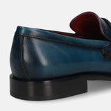 A blue Men's bugatti Penny Loafer featuring a round toe apron toe, stacked heel. Made from premium genuine leather with a durable leather outsole, this slip-on design offers both style and comfort.