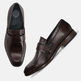 A brown Men's bugatti Penny Loafer featuring a round toe apron toe, stacked heel. Made from premium genuine leather with a durable leather outsole, this slip-on design offers both style and comfort.