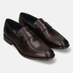 A brown Men's bugatti Penny Loafer featuring a round toe apron toe, stacked heel. Made from premium genuine leather with a durable leather outsole, this slip-on design offers both style and comfort.