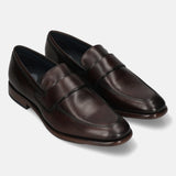 A brown Men's bugatti Penny Loafer featuring a round toe apron toe, stacked heel. Made from premium genuine leather with a durable leather outsole, this slip-on design offers both style and comfort.