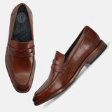 A cognac Men's bugatti Penny Loafer featuring a round toe apron toe, stacked heel. Made from premium genuine leather with a durable leather outsole, this slip-on design offers both style and comfort.