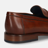 A cognac Men's bugatti Penny Loafer featuring a round toe apron toe, stacked heel. Made from premium genuine leather with a durable leather outsole, this slip-on design offers both style and comfort.