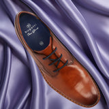 A cognac Men's bugatti Derby featuring a round toe plain toe, stacked heel. Made from premium genuine leather with a durable eva outsole, this laces design offers both style and comfort.