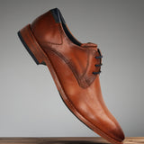 A cognac Men's bugatti Derby featuring a pointed toe plain toe, stacked heel. Made from premium genuine leather with a durable leather outsole, this laces design offers both style and comfort.