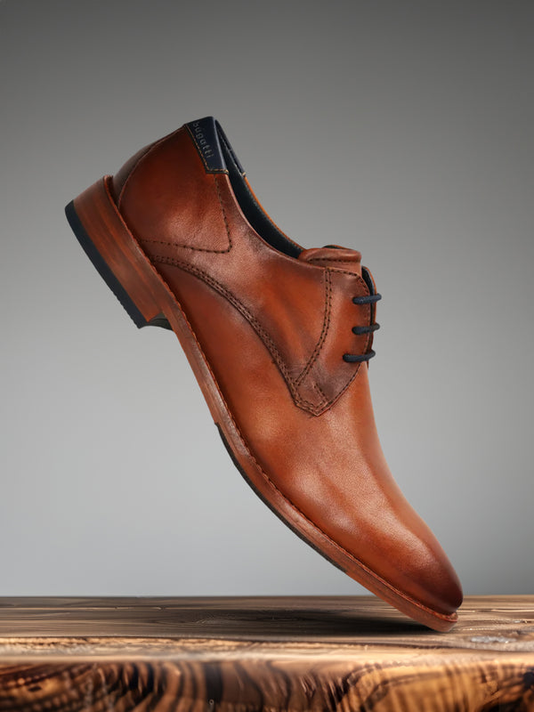 A cognac Men's bugatti Derby featuring a pointed toe plain toe, stacked heel. Made from premium genuine leather with a durable leather outsole, this laces design offers both style and comfort.