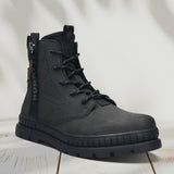 A black Men's bugatti Casual Boots featuring a round toe plain toe, stacked heel. Made from synthetic with a durable tpr outsole, this zipper design offers both style and comfort.