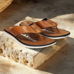 A cognac Men's bugatti Thongs featuring a round open toe, zero heels heel. Made from premium genuine leather with a durable synthetic outsole, this slip-on design offers both style and comfort.